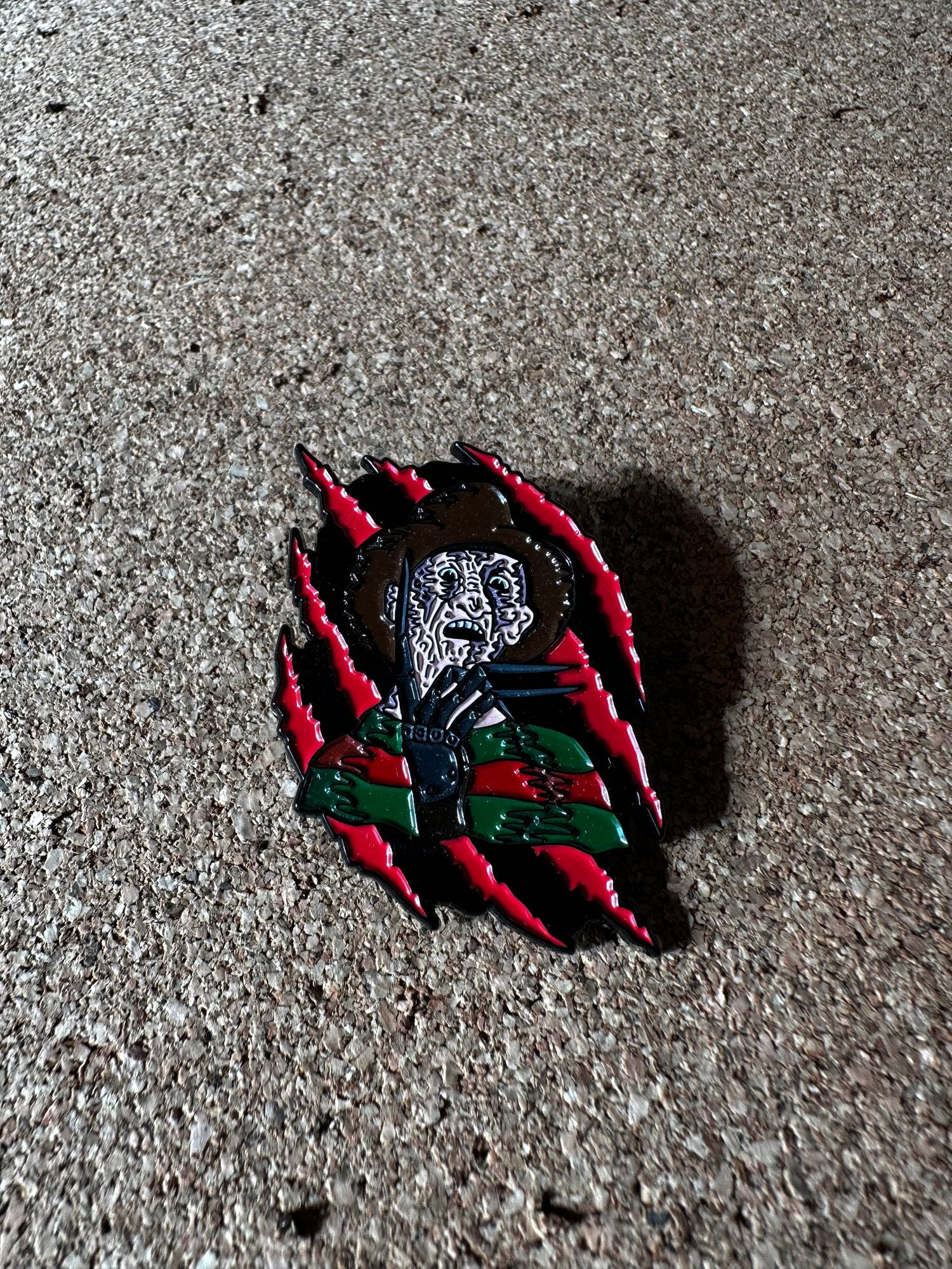 SLASHING FREDDY ENAMEL PIN